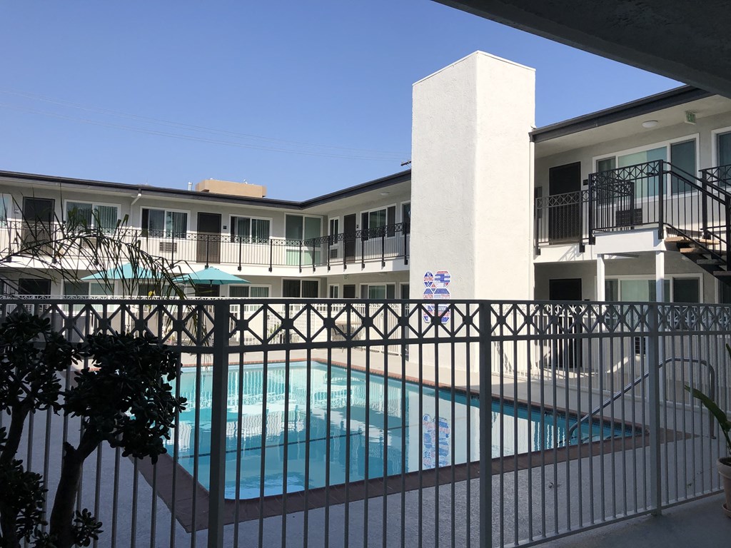 the view of the pool from the balcony of a hotel