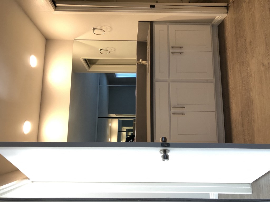 a large bathroom mirror with a sink in front of it