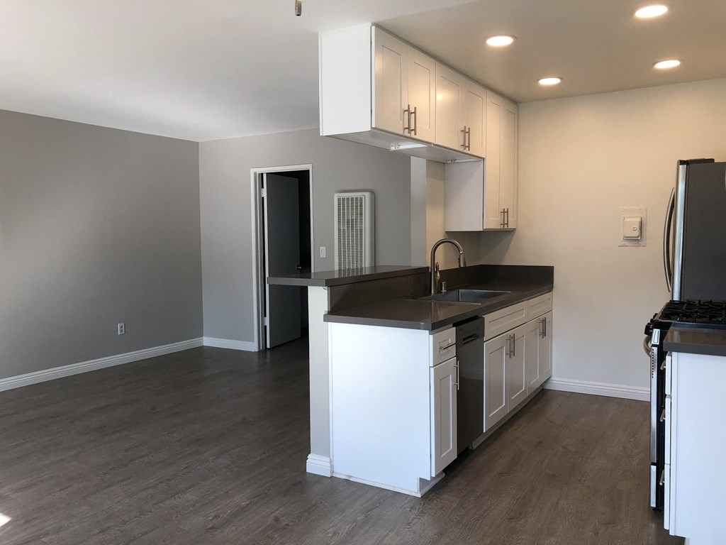 a kitchen with an island and a stove and a refrigerator