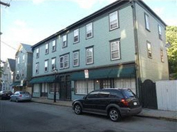 a car parked in front of a building on a street