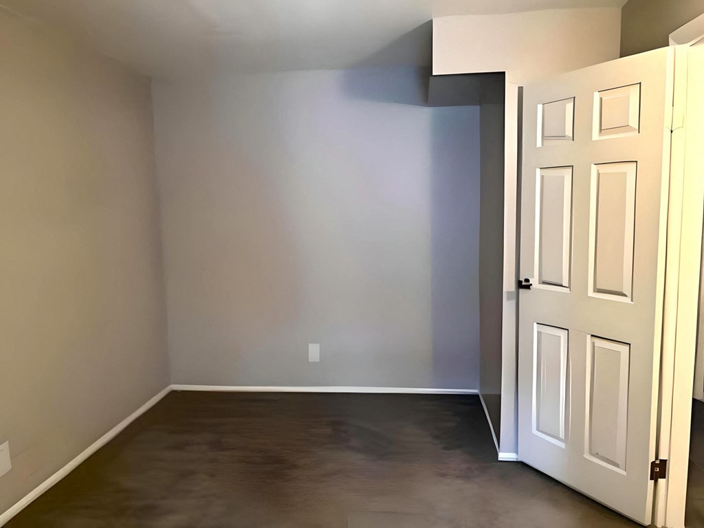 a room with gray walls and a white door