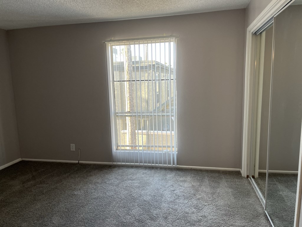 an empty living room with a large window