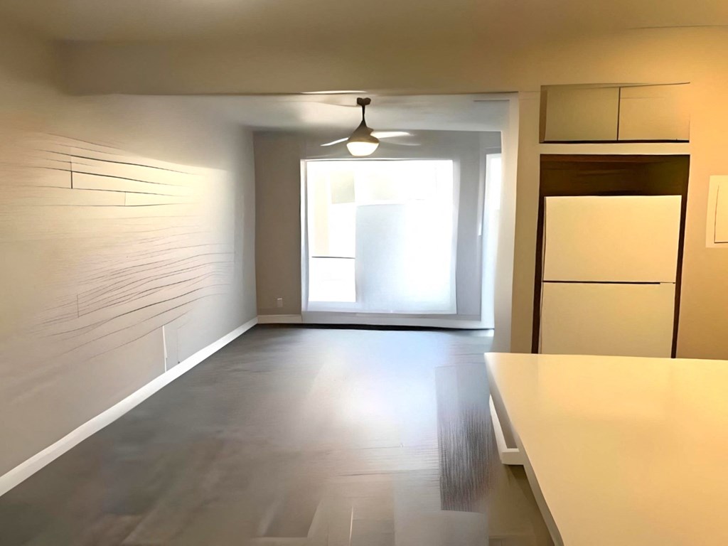a empty room with a kitchen and a window