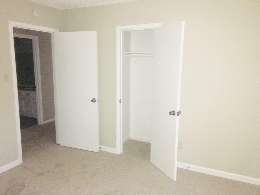 an empty room with three white doors in it