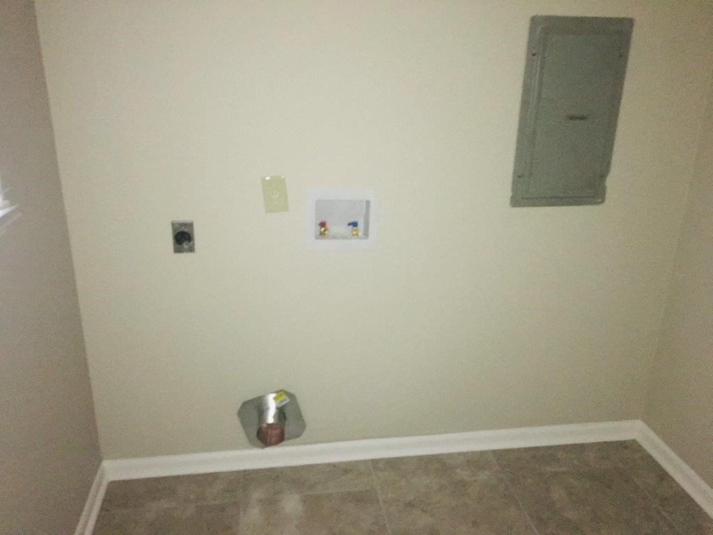 a wall with a silver urinal in a room