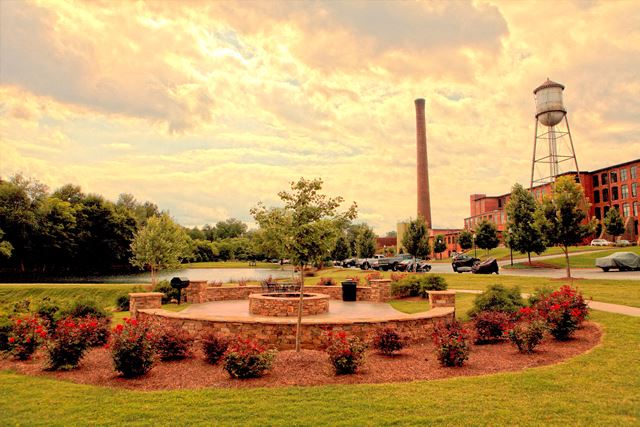 a park with a fountain and a water tower