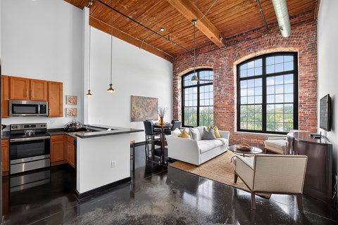 A kitchen with a white counter top and a black stove top oven.