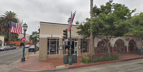 A street view of a building with a red awning and a sign that reads "Peninsula".
