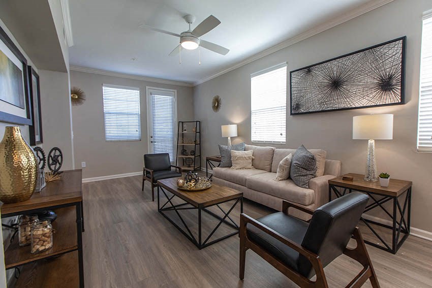 a living room with a couch and a ceiling fan