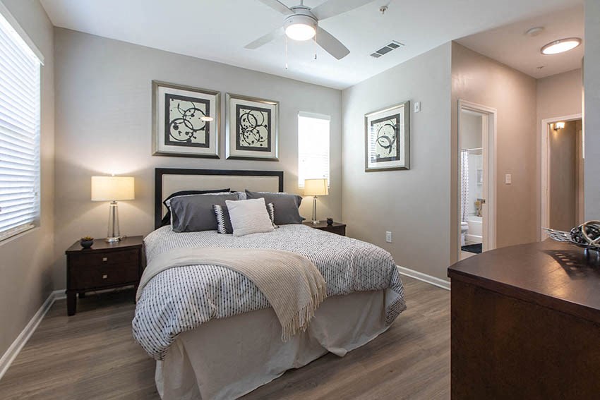 a bedroom with a bed and a ceiling fan