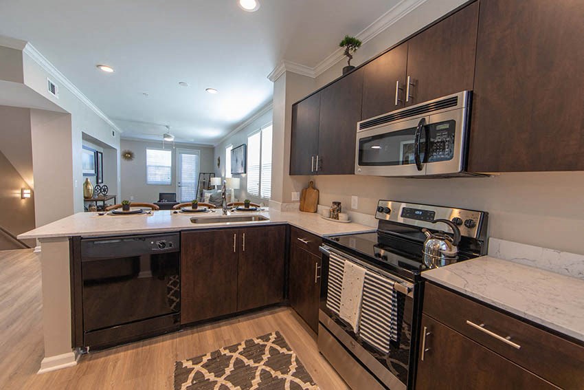 a kitchen with a stove microwave and sink