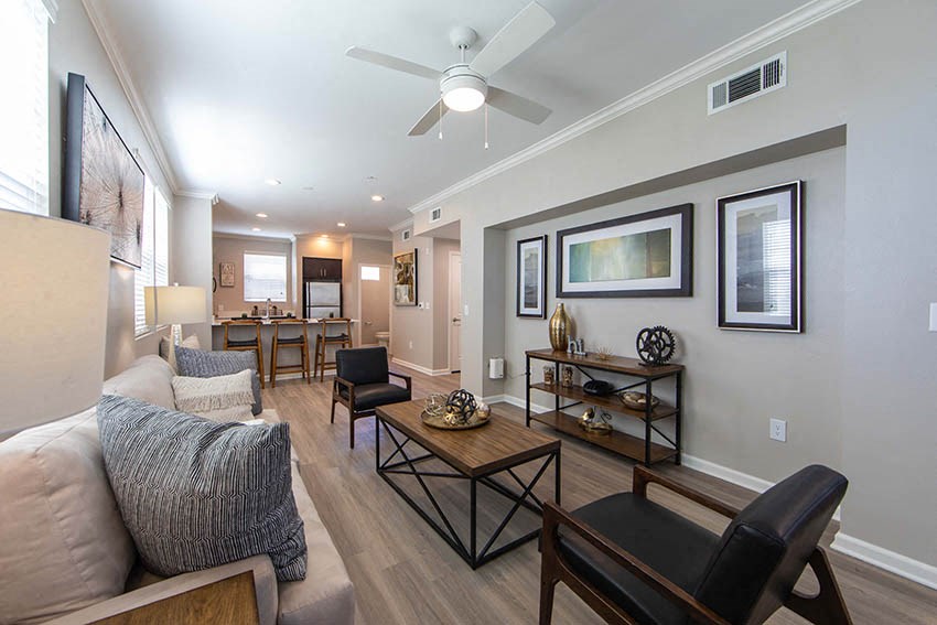 a living room with a couch and a ceiling fan