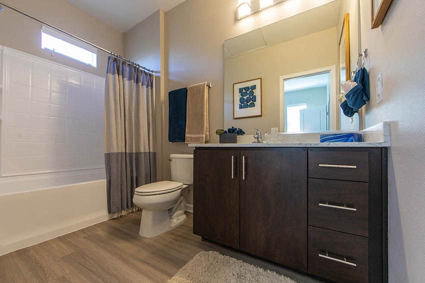 a bathroom with a toilet and a shower and a sink