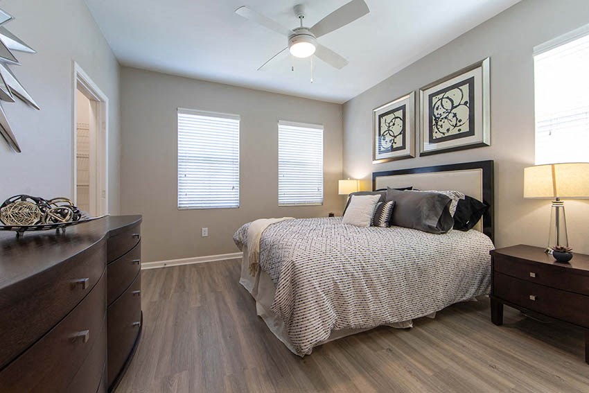 a bedroom with a bed and a ceiling fan