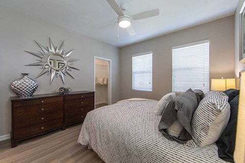 a bedroom with a bed and a ceiling fan