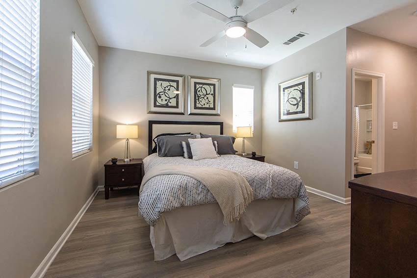 a bedroom with a bed and a ceiling fan