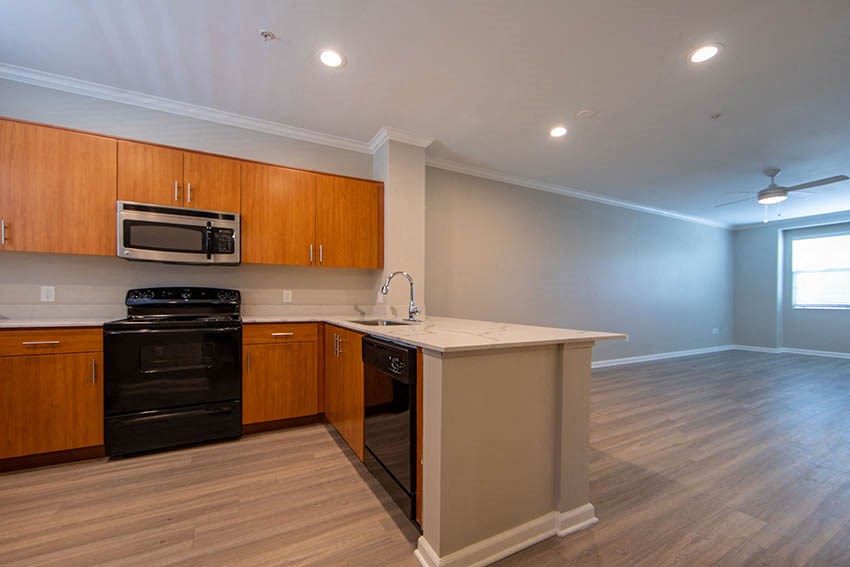 a kitchen with an island and a stove and a microwave
