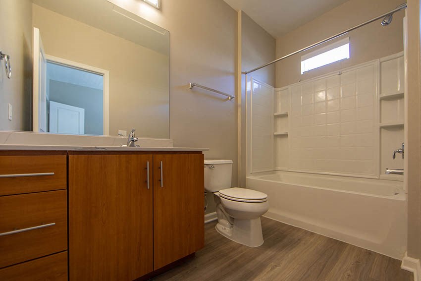 a bathroom with a toilet and a shower and a sink