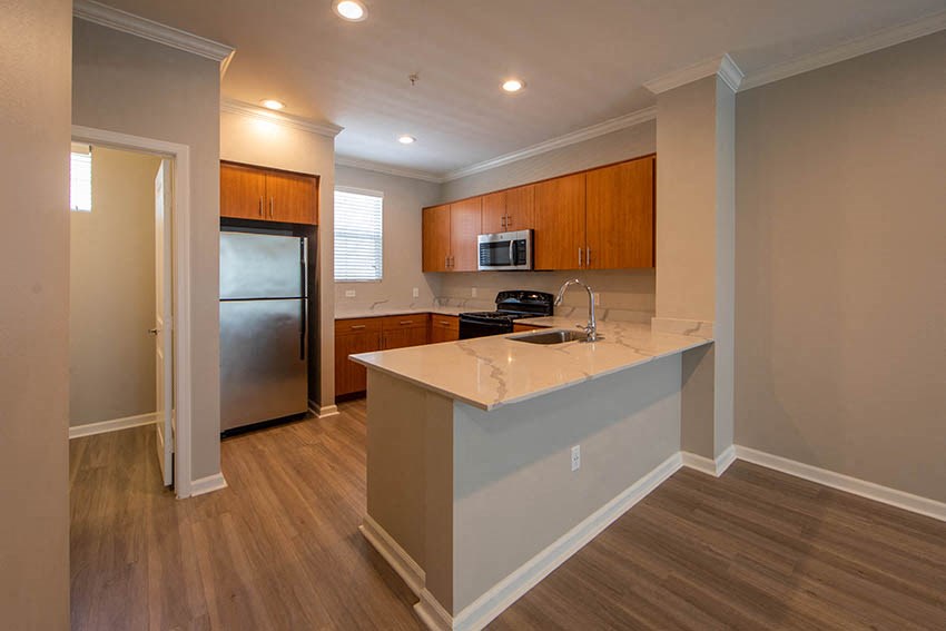 a kitchen with a counter top and a refrigerator