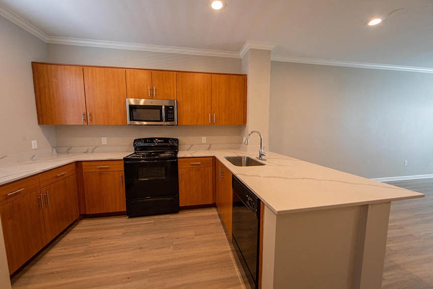 a kitchen with an island and a stove and a sink