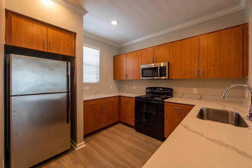 a kitchen with stainless steel appliances and wooden cabinets