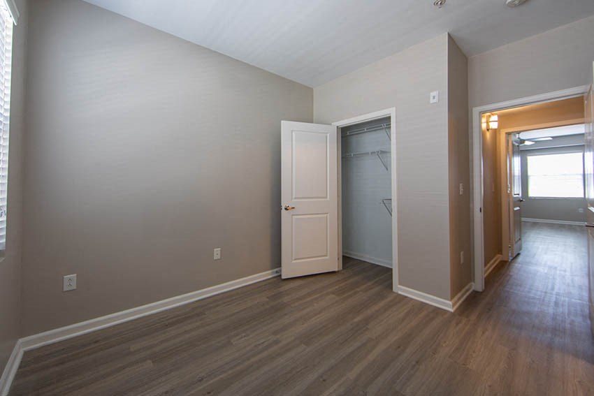 an empty living room with a door to a closet