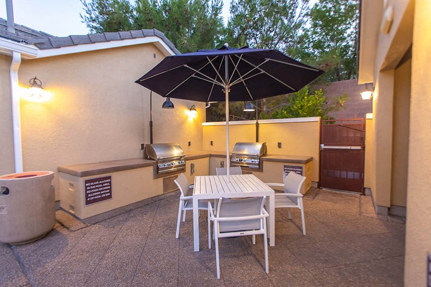 a patio with a table and chairs and an umbrella