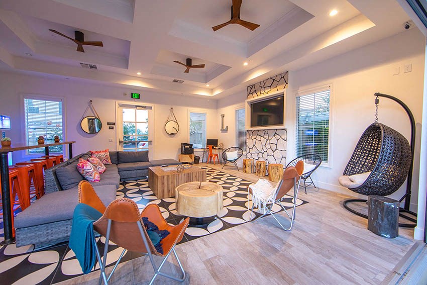 a living room with a couch and chairs and a television