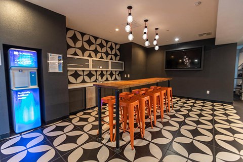 a dining room with a table and chairs and a refrigerator