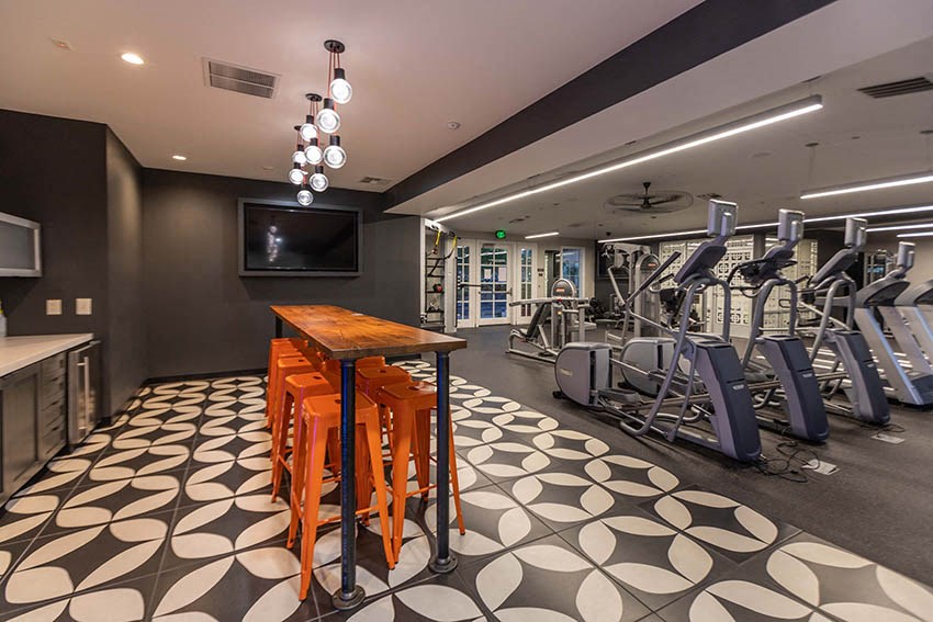 a gym with exercise machines and a television
