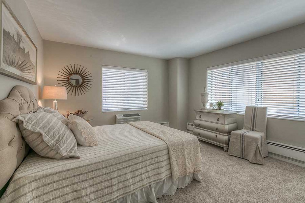 a bedroom with a bed and a dresser