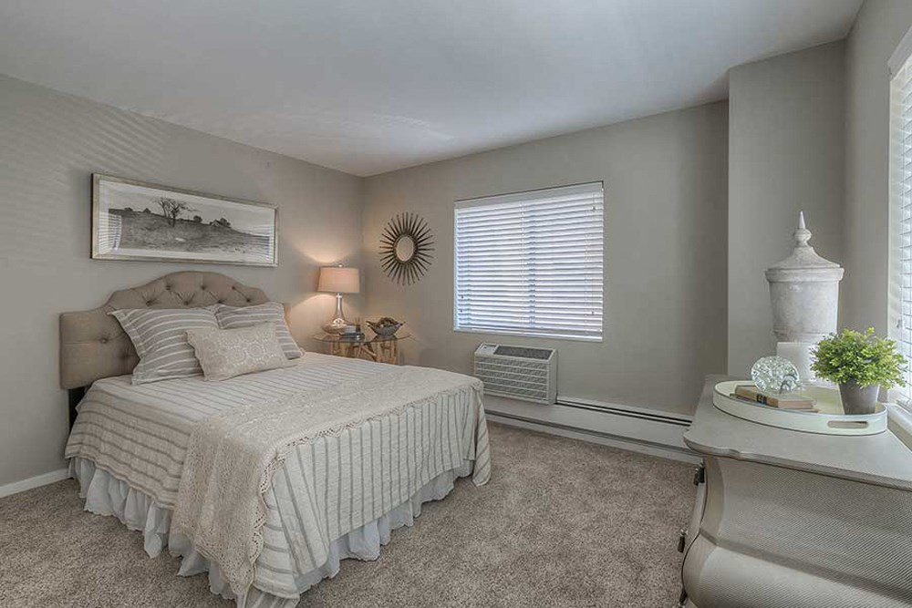 a bedroom with a bed and a window