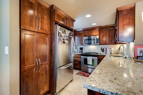 a kitchen with stainless steel appliances and wooden cabinets