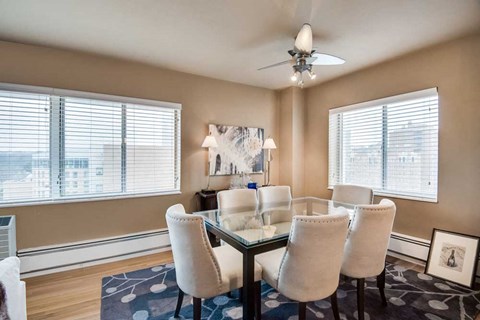 a dining room with a table and chairs and a ceiling fan