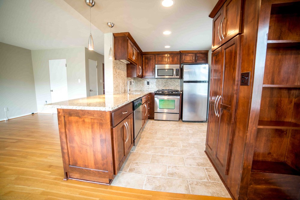 a kitchen with wooden cabinets and stainless steel appliances