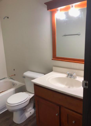 a bathroom with a sink toilet and a mirror