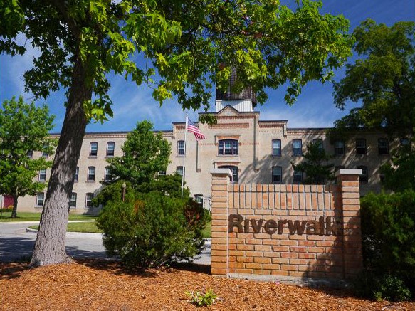 the riverwalk sign in front of a building