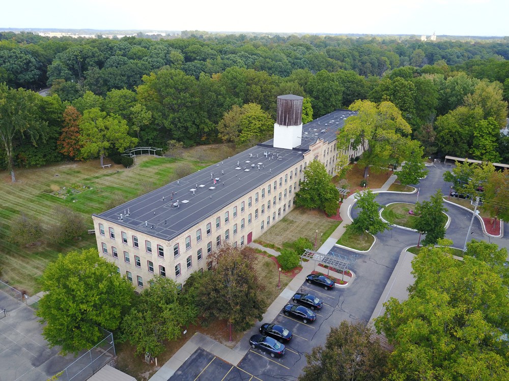 an aerial view of a building with a water tower