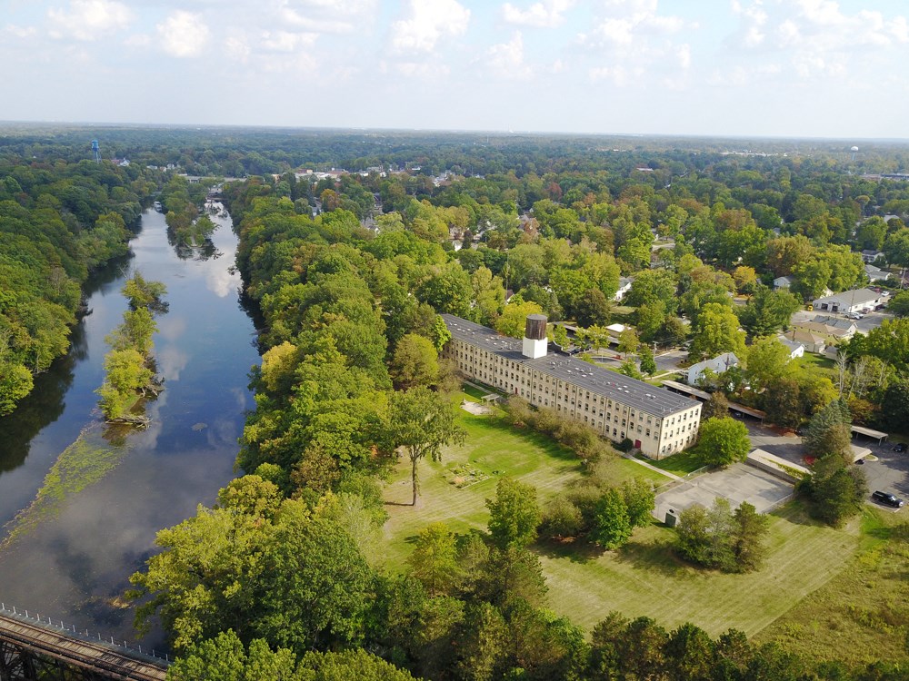 an aerial view of a building next to a river
