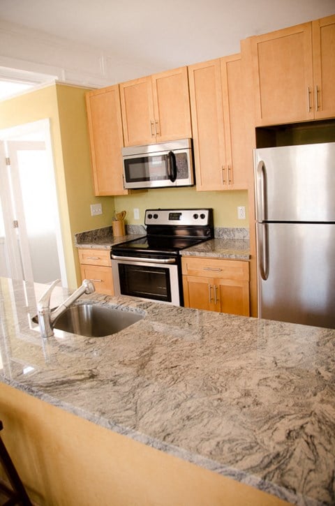 a kitchen with granite counter tops and stainless steel appliances