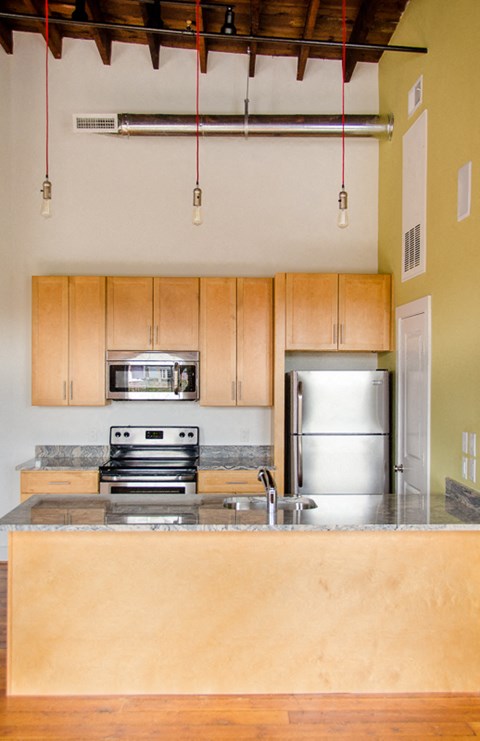 a kitchen with wooden cabinets and stainless steel appliances