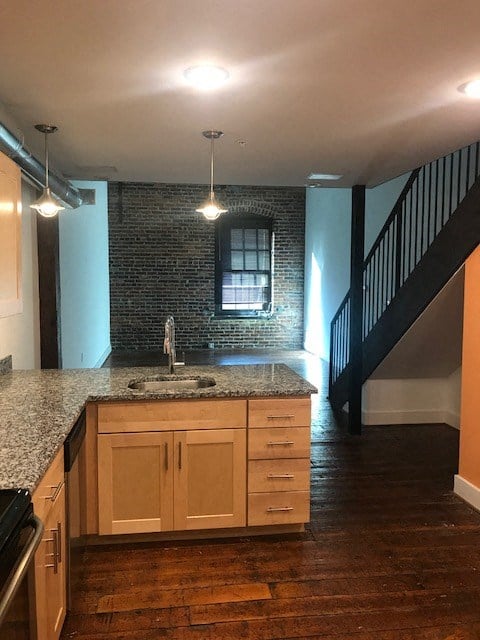 an empty kitchen with a sink and a counter top