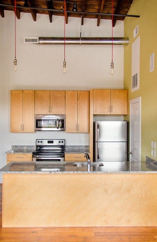 a kitchen with wooden cabinets and stainless steel appliances