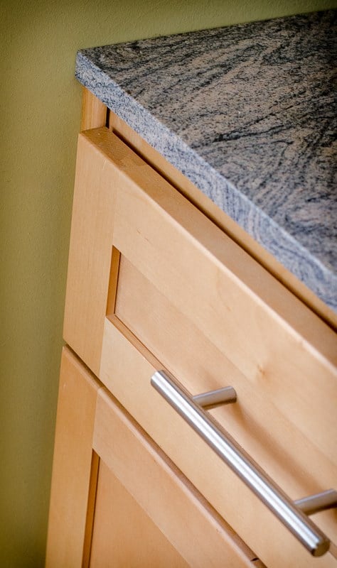 a kitchen counter with drawers and a granite counter top