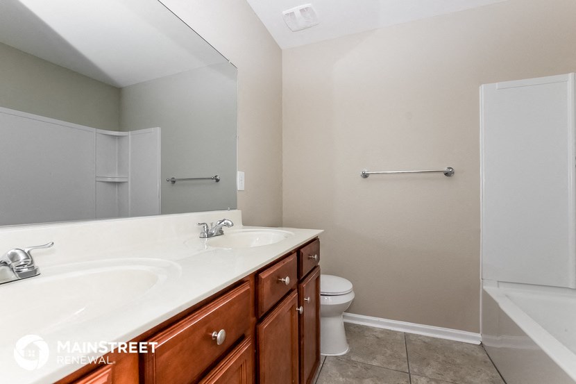 a bathroom with a sink and a toilet and a mirror