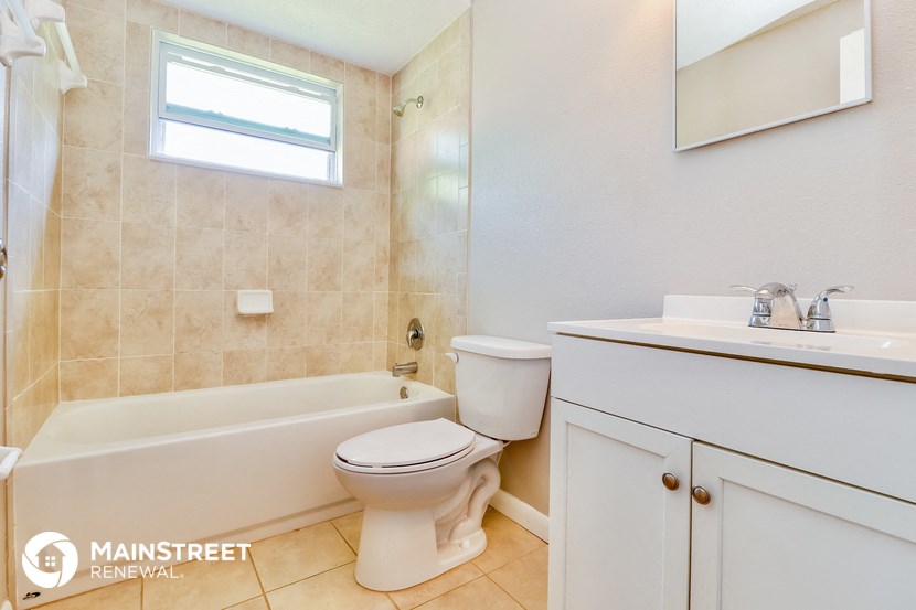 a bathroom with a toilet and a tub and a sink
