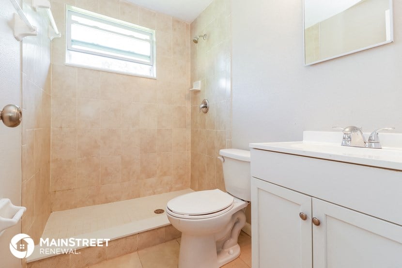 a bathroom with a toilet and a sink and a shower