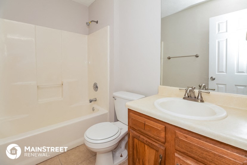 a bathroom with a sink toilet and a shower
