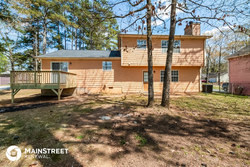 the front of a house with a deck and a porch