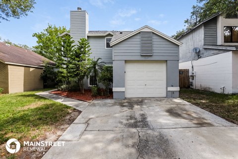 a garage with a white garage door in front of a house